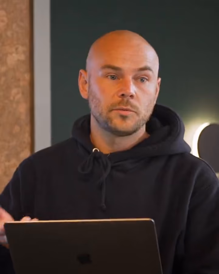 Liam, Creative Director at Harper, at a desk in the Harper office